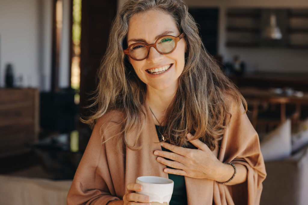 Woman smiling drinking CBD coffee